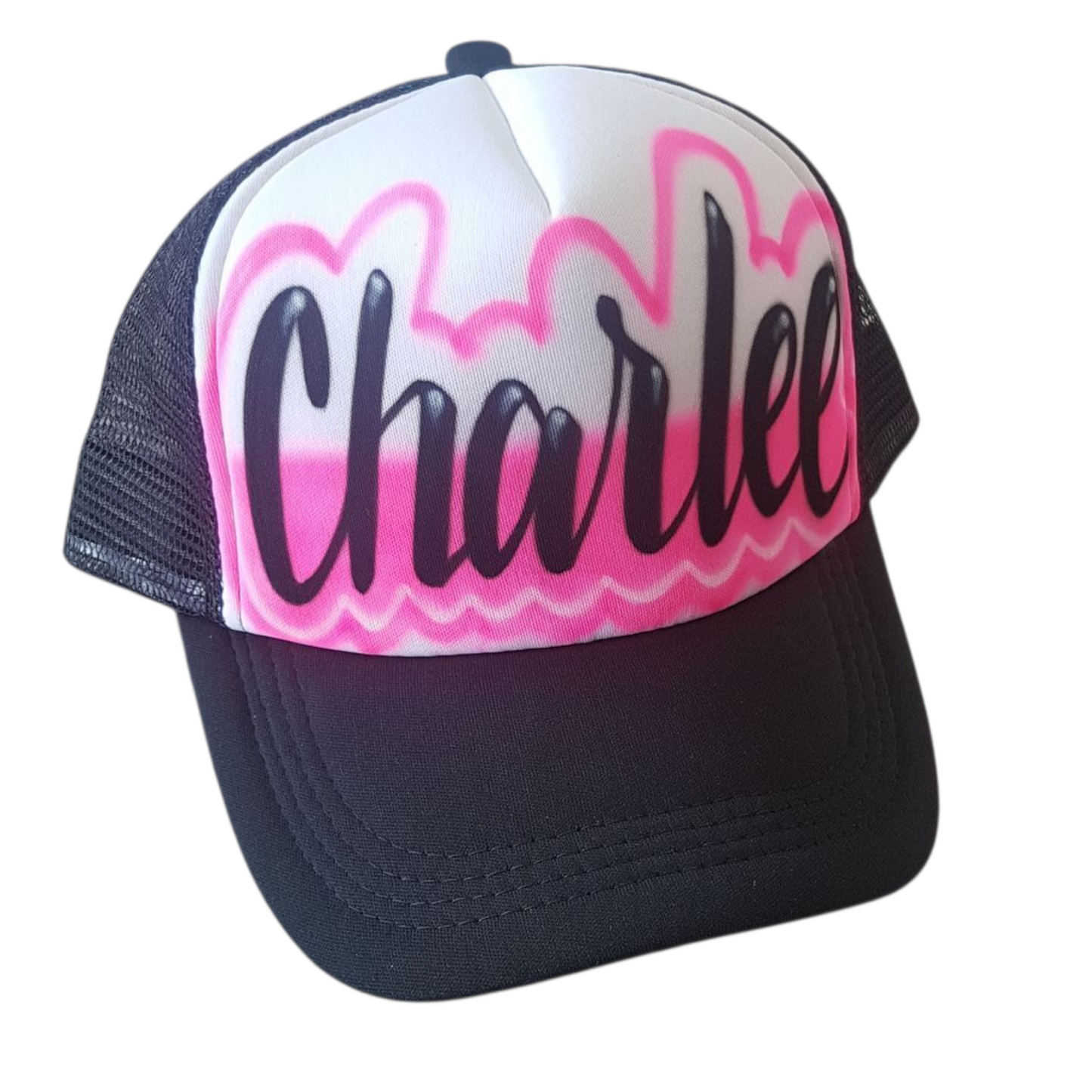 Black trucker cap with pink design and black airbrush script text "Charlee"  on a white background