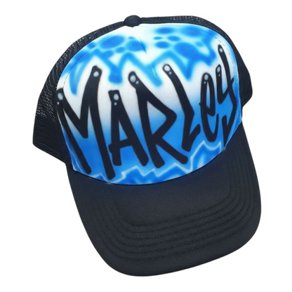 Black trucker cap with blue and white design and 'Marley' text on a white background