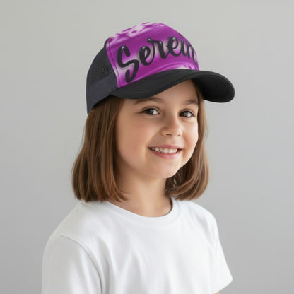 Child wearing a black trucker cap with purple purple airbrush design with 'Serena' in script on a gray background