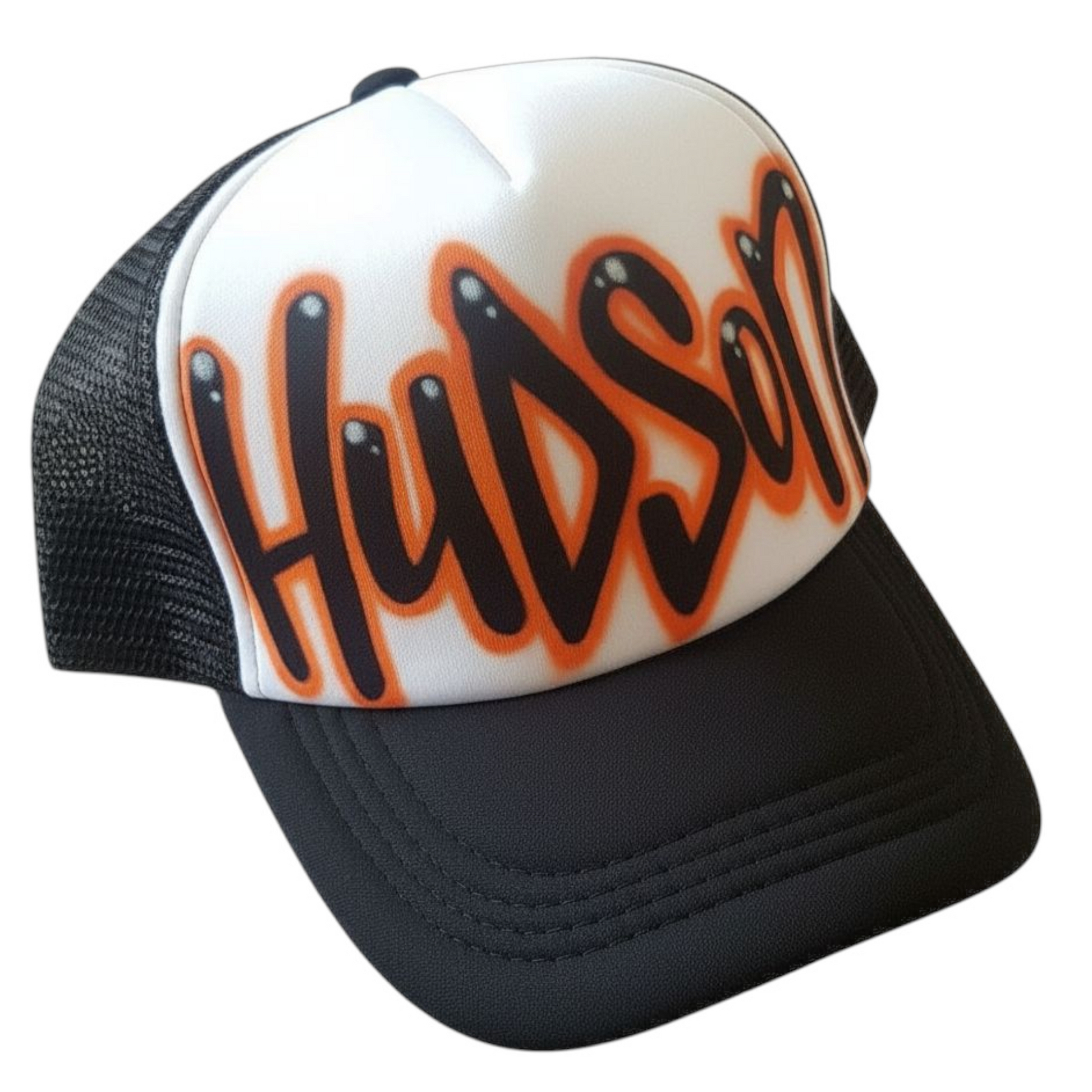 Black and white trucker cap with 'Hudson' airbrushed in orange and black on a white background